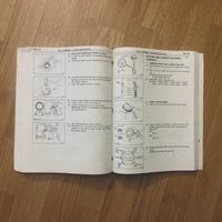 The factory service manual opened to a page describing steps for a job
